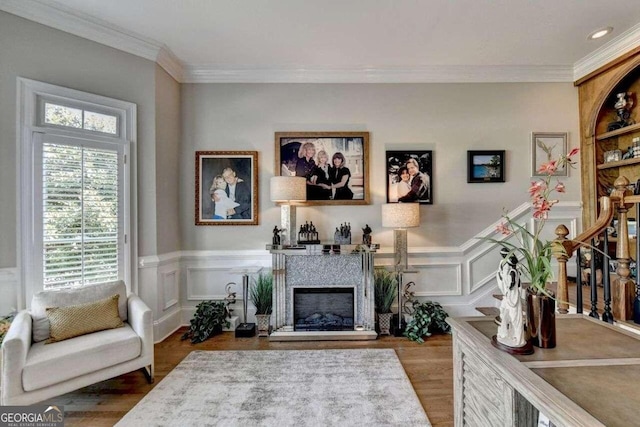 sitting room with crown molding and hardwood / wood-style flooring