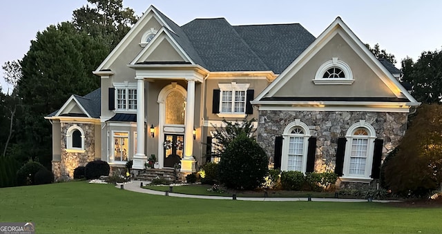 view of front of property with a front lawn and french doors