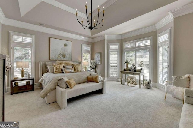 bedroom with ornamental molding, light carpet, a tray ceiling, and a chandelier