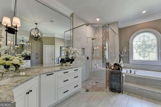 bathroom with a notable chandelier, crown molding, vanity, and plus walk in shower