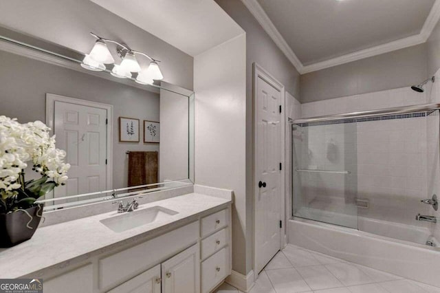 bathroom featuring ornamental molding, vanity, combined bath / shower with glass door, and tile patterned floors