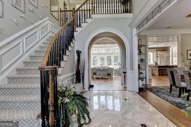 entryway featuring ornamental molding and hardwood / wood-style floors