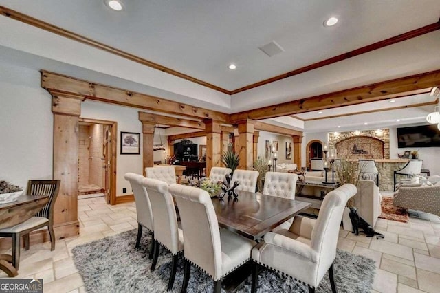 dining area featuring ornate columns and crown molding