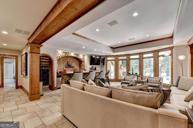 office with a tray ceiling and ornamental molding