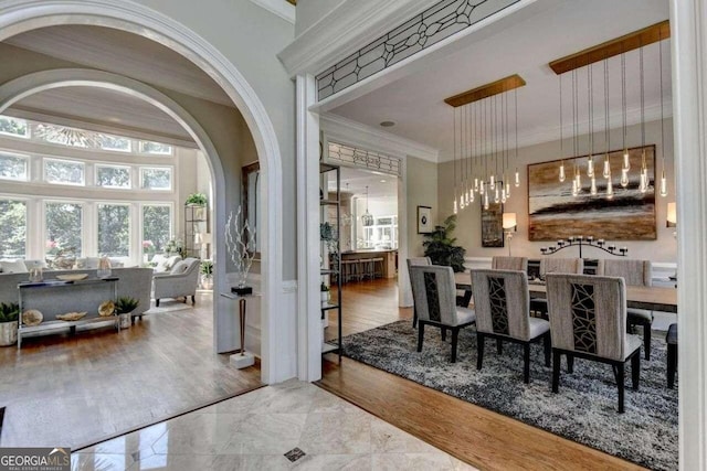 dining space with crown molding and hardwood / wood-style flooring