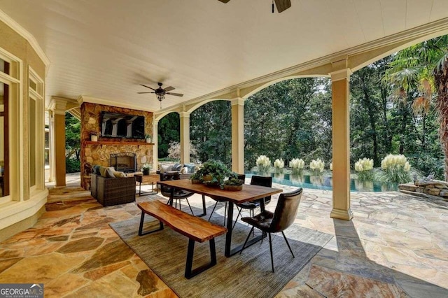 view of patio / terrace featuring an outdoor living space with a fireplace and ceiling fan