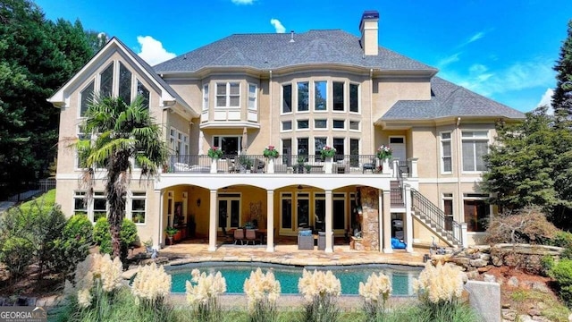 rear view of house featuring outdoor lounge area and a patio area