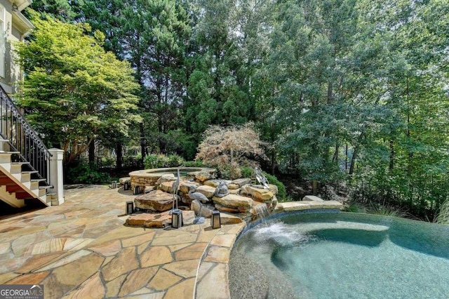 view of swimming pool featuring a patio and pool water feature