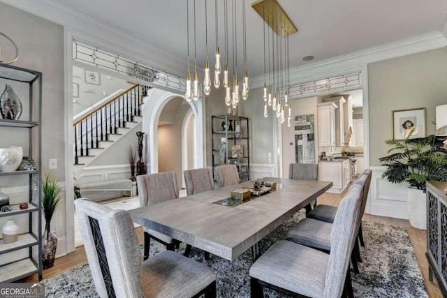 dining room with ornamental molding and hardwood / wood-style floors