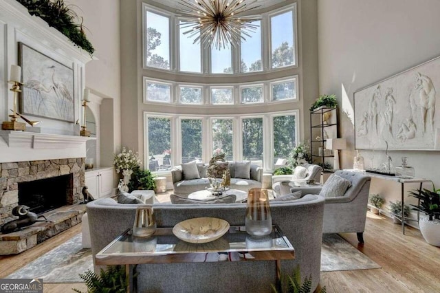 interior space featuring a stone fireplace, a chandelier, and a wealth of natural light