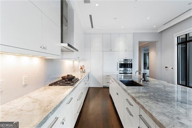 kitchen featuring light stone countertops, stainless steel appliances, white cabinets, dark wood-type flooring, and sink