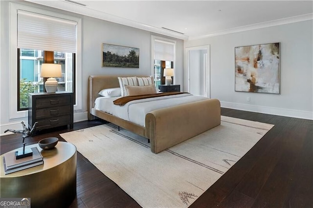 bedroom featuring crown molding and dark hardwood / wood-style flooring