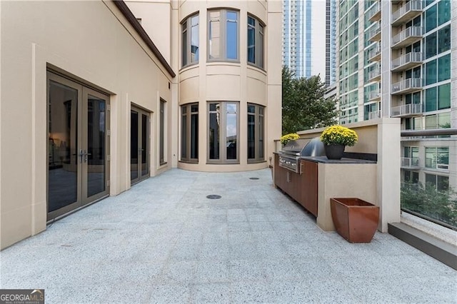 view of patio featuring area for grilling and a balcony