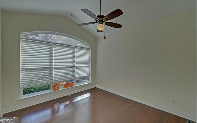 unfurnished room featuring dark hardwood / wood-style floors, vaulted ceiling, and a healthy amount of sunlight