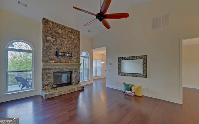 living room featuring a fireplace, ceiling fan, dark wood-type flooring, and high vaulted ceiling