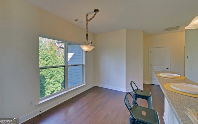 dining room with sink and dark wood-type flooring