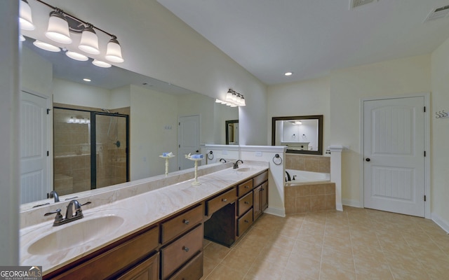 bathroom with shower with separate bathtub, vanity, and tile patterned floors