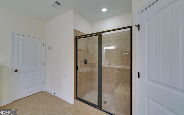 bathroom with tile patterned flooring and an enclosed shower