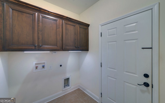 washroom featuring washer hookup, electric dryer hookup, cabinets, and light tile patterned floors