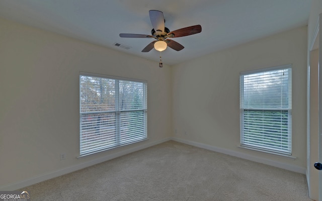 unfurnished room featuring ceiling fan and light colored carpet