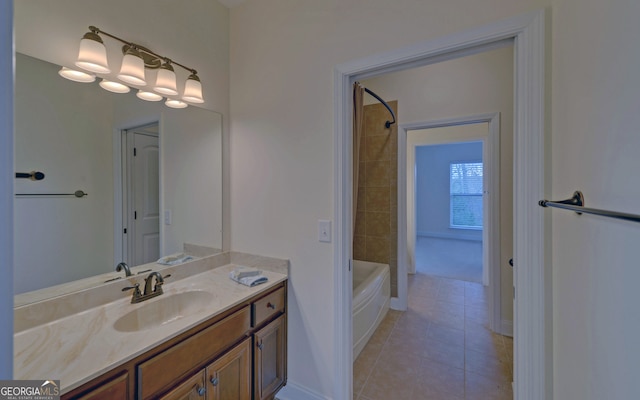 bathroom featuring tile patterned floors, vanity, and tiled shower / bath