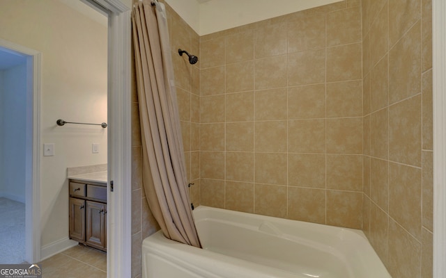 bathroom featuring tile patterned flooring, shower / bath combo, and vanity