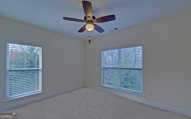 carpeted empty room featuring ceiling fan