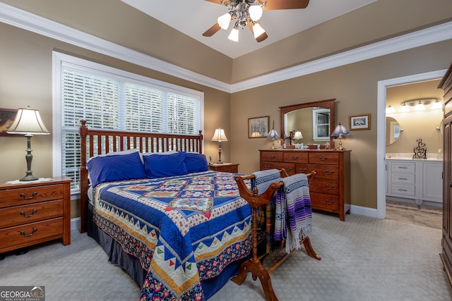 carpeted bedroom featuring ornamental molding, ensuite bathroom, and ceiling fan