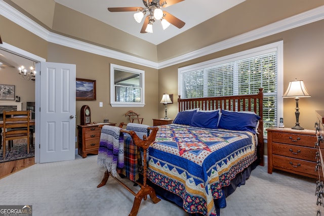 carpeted bedroom with ceiling fan and ornamental molding