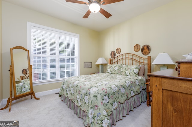 carpeted bedroom with multiple windows and ceiling fan