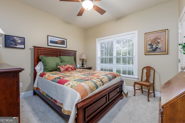 bedroom with ceiling fan and light colored carpet