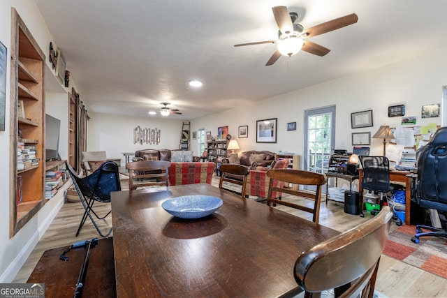 dining area with light hardwood / wood-style floors and ceiling fan