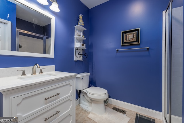 bathroom featuring vanity, a shower with shower door, toilet, and tile patterned flooring