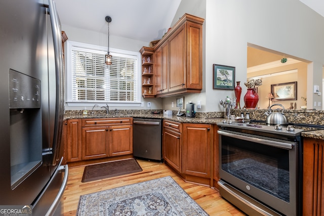 kitchen with lofted ceiling, light hardwood / wood-style floors, appliances with stainless steel finishes, and sink