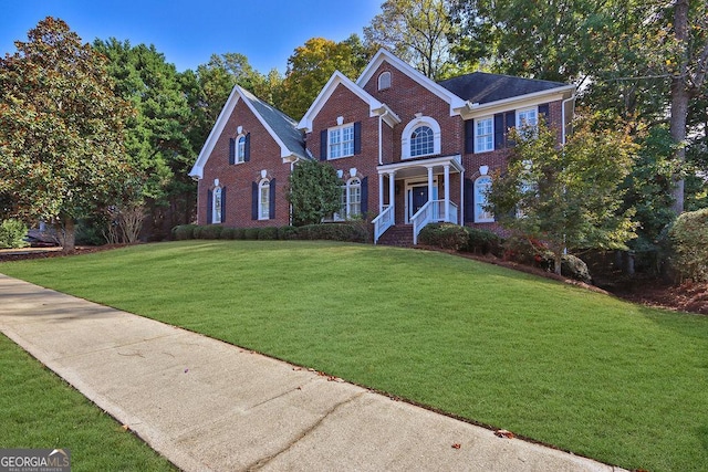 colonial home featuring a front lawn