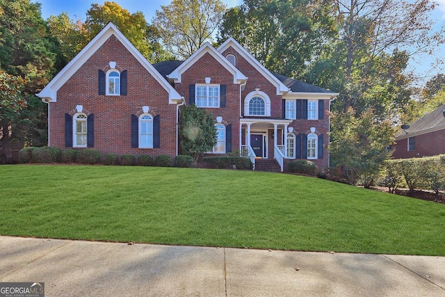 colonial-style house with a front yard