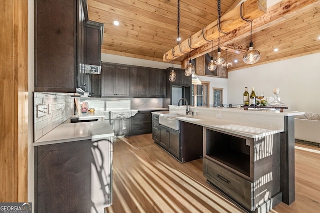 kitchen featuring wood ceiling, a kitchen island with sink, light wood-type flooring, dark brown cabinetry, and decorative light fixtures