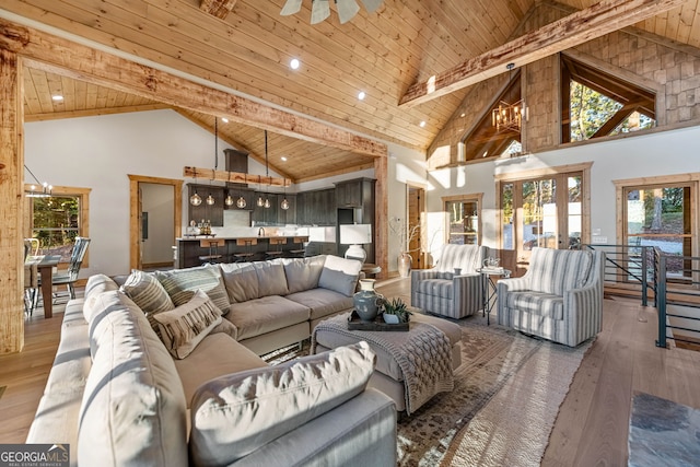 living room featuring a wealth of natural light, hardwood / wood-style floors, and high vaulted ceiling