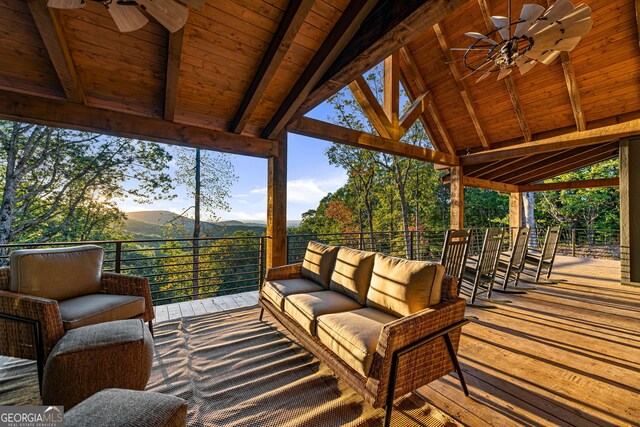 exterior space with ceiling fan, a mountain view, and an outdoor living space