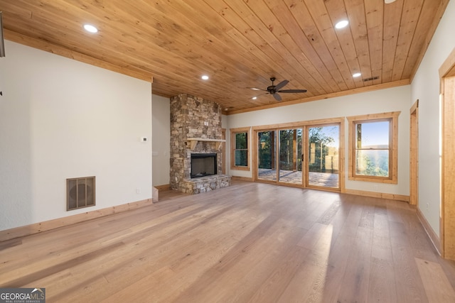 unfurnished living room featuring light hardwood / wood-style floors, wood ceiling, a fireplace, and ceiling fan