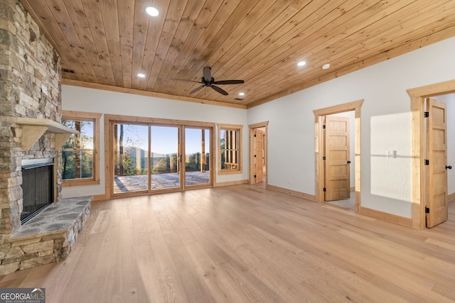 unfurnished living room with ceiling fan, a stone fireplace, wooden ceiling, and light wood-type flooring