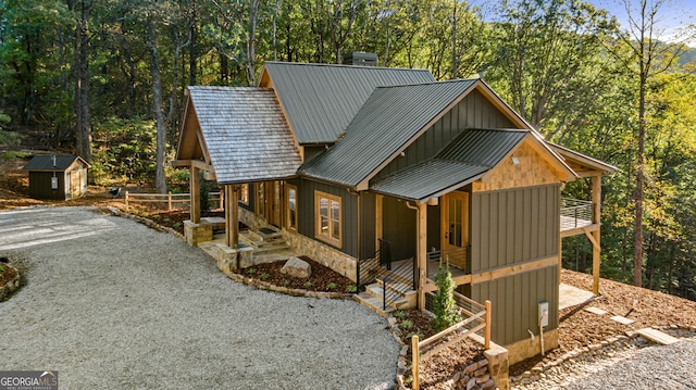 view of property exterior with a storage unit