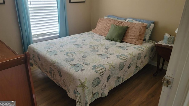 bedroom with dark hardwood / wood-style flooring