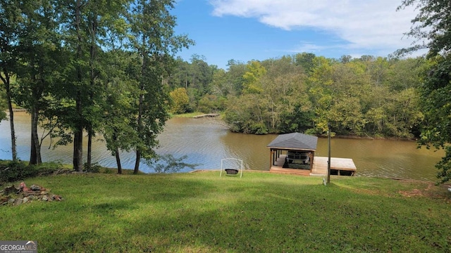 dock area with a lawn and a water view