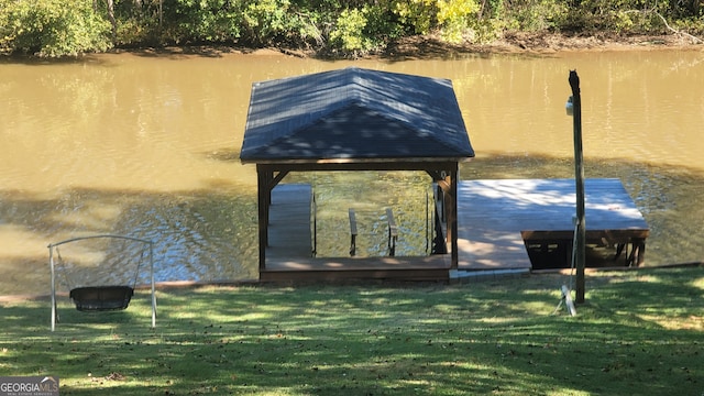 view of dock featuring a yard and a water view