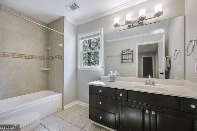 full bathroom featuring tile patterned floors, toilet, tiled shower / bath, ornamental molding, and vanity