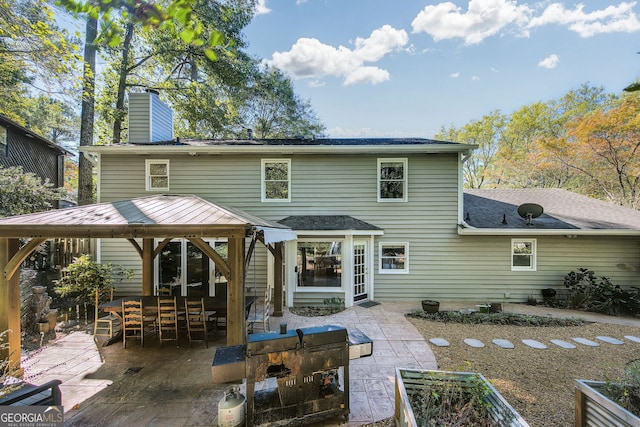 back of house with a gazebo and a patio