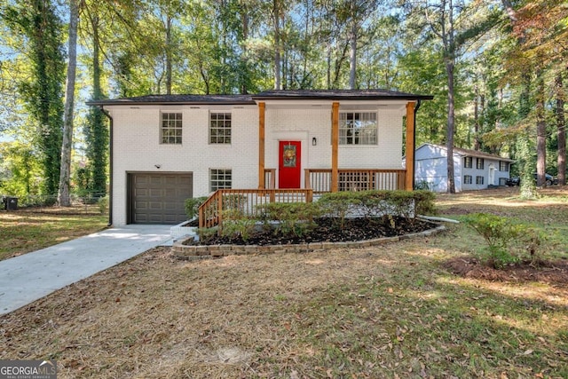 bi-level home featuring a porch and a garage