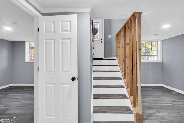 staircase featuring crown molding, hardwood / wood-style flooring, and a textured ceiling