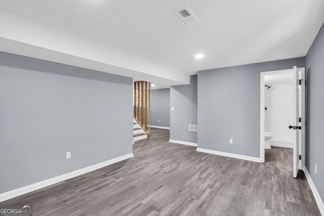 basement with hardwood / wood-style flooring